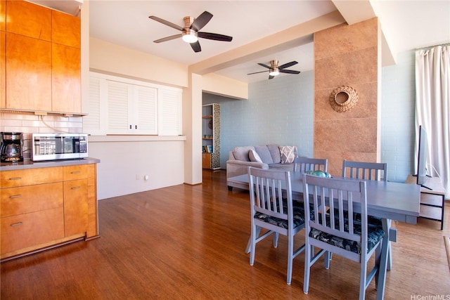 dining room featuring a ceiling fan and dark wood-style floors