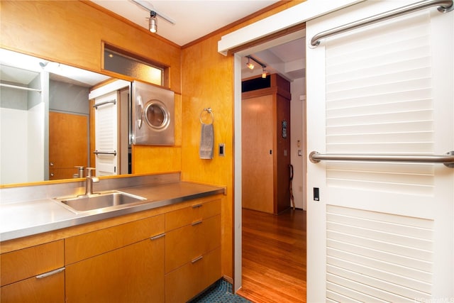 kitchen with a sink, light countertops, and dark wood-style floors
