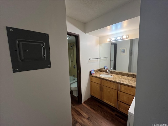 bathroom featuring shower / tub combination, vanity, electric panel, toilet, and wood finished floors