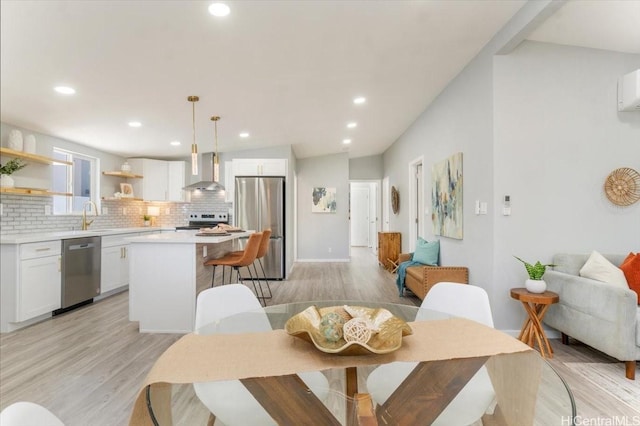 dining space featuring recessed lighting and light wood-style flooring