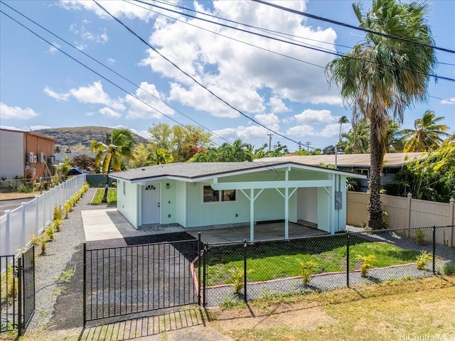 bungalow-style house with a fenced front yard and a gate
