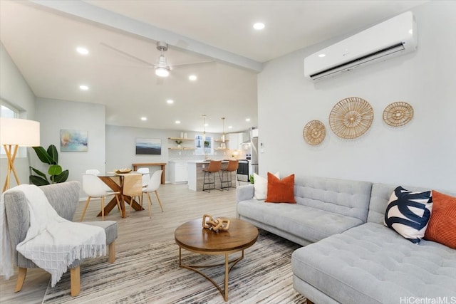 living area featuring recessed lighting, a wall unit AC, a ceiling fan, and light wood-style flooring