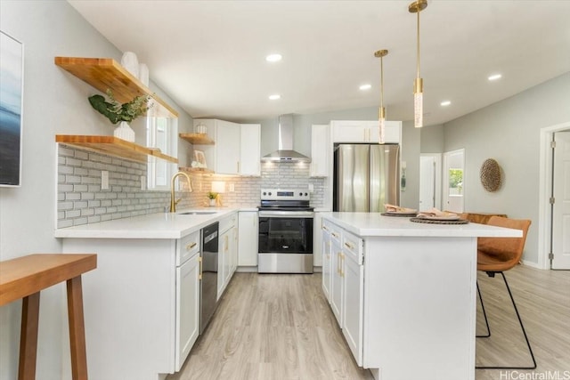 kitchen with a sink, stainless steel appliances, a kitchen breakfast bar, open shelves, and wall chimney exhaust hood