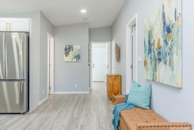 sitting room with baseboards, recessed lighting, and light wood-style flooring