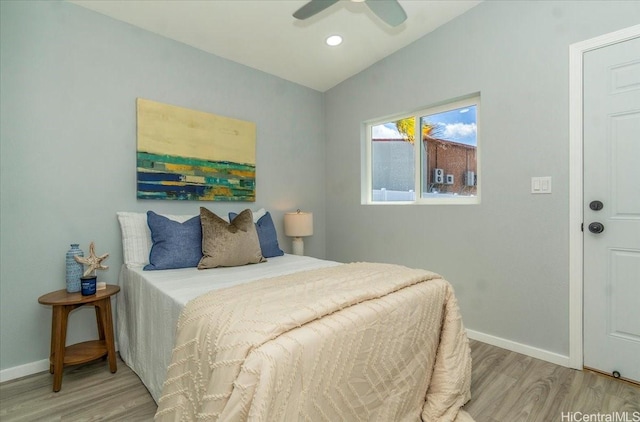 bedroom with a ceiling fan, light wood finished floors, and baseboards