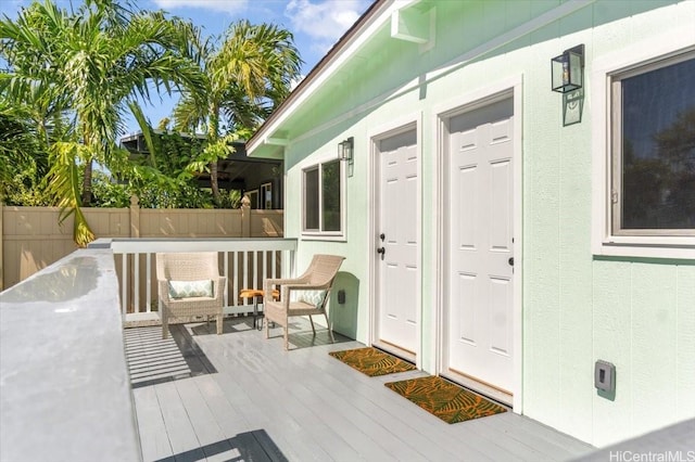 property entrance with a deck and fence