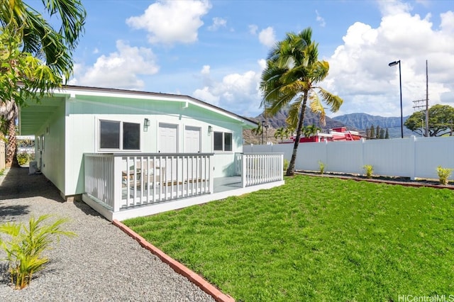 view of yard featuring a mountain view and fence