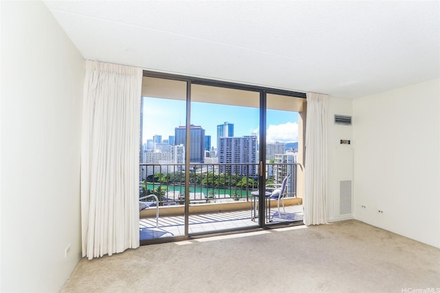 411 Hobron Ln Unit 1710, Honolulu, HI 96813 - carpeted spare room featuring a wall of windows and a skyline view