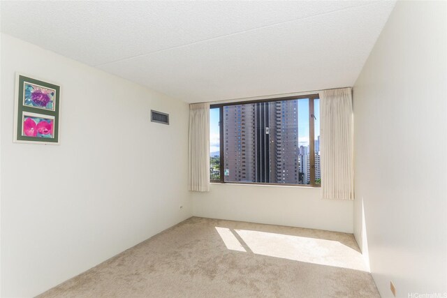 411 Hobron Ln Unit 1710, Honolulu, HI 96813 - unfurnished room with carpet floors and healthy amount of natural light