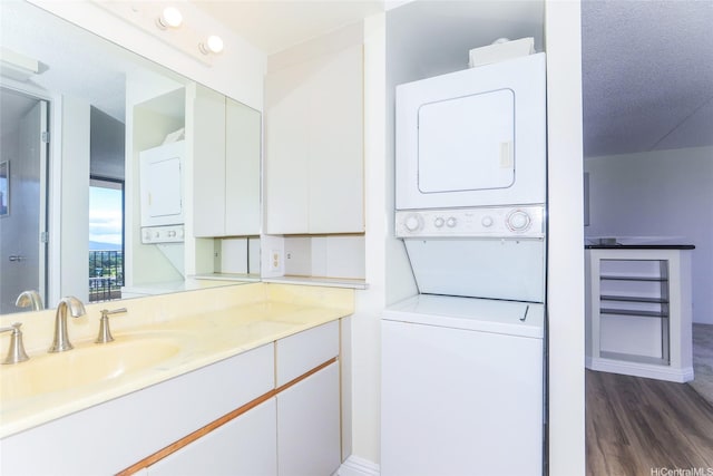 411 Hobron Ln Unit 1710, Honolulu, HI 96813 - bathroom with stacked washer / drying machine, wood finished floors, and vanity