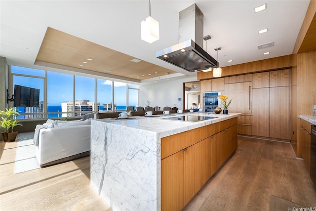 1009 Kapiolani Blvd Ph 4802, Honolulu, HI 96814 - kitchen featuring hardwood / wood-style flooring, open floor plan, black electric stovetop, and island range hood