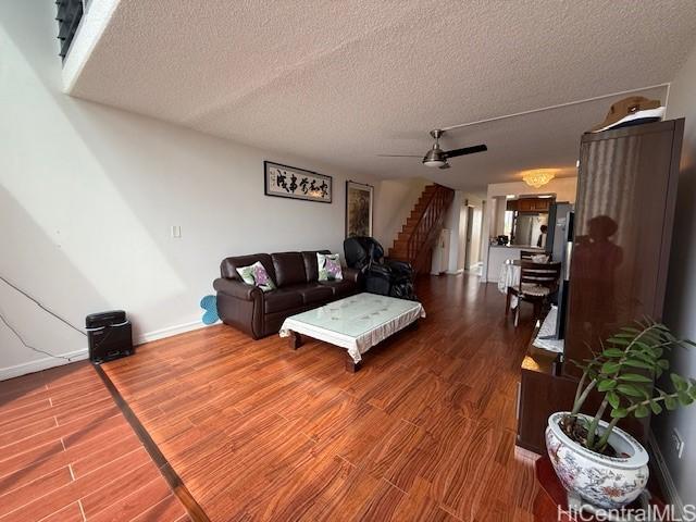 500 University Ave Unit 917, Honolulu, HI 96826 - living area with a textured ceiling, wood finished floors, and stairway