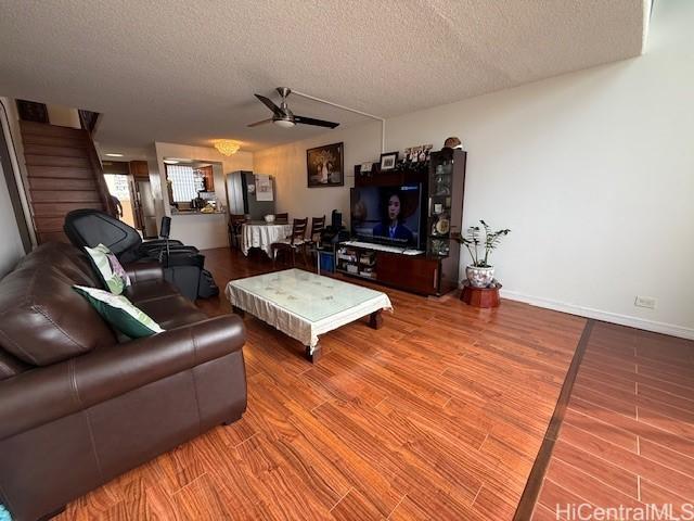 500 University Ave Unit 917, Honolulu, HI 96826 - living area featuring a textured ceiling, ceiling fan, and wood finished floors