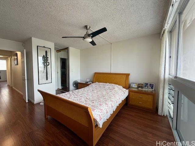 500 University Ave Unit 917, Honolulu, HI 96826 - bedroom with a textured ceiling, dark wood-style flooring, and ceiling fan