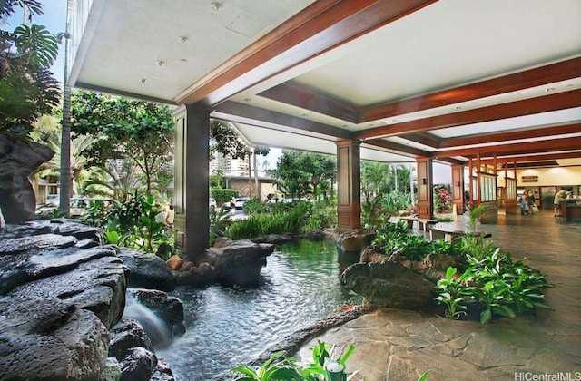 exterior space with a garden pond
