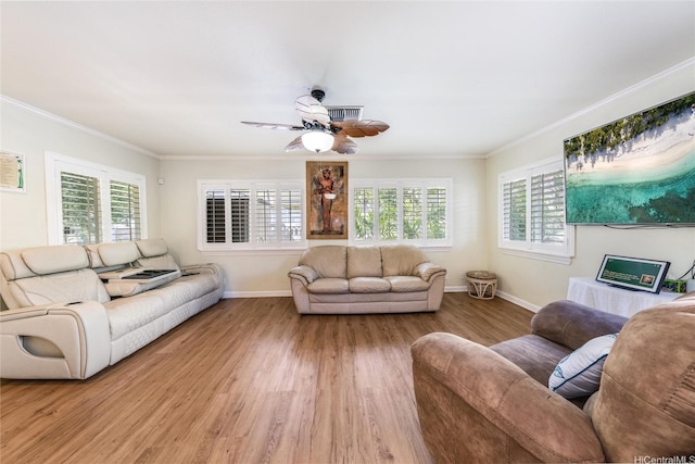 living area with baseboards, ornamental molding, and light wood finished floors