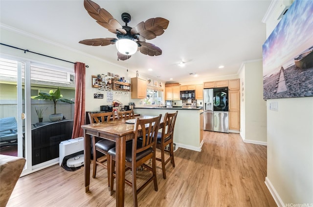 dining area with a wealth of natural light, ornamental molding, and light wood-type flooring
