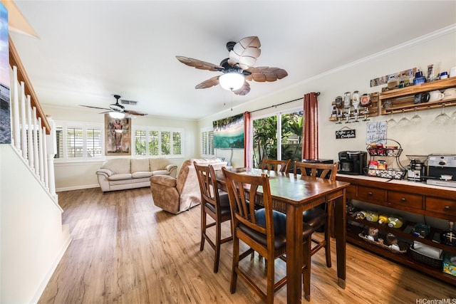 dining area featuring light wood-type flooring, a healthy amount of sunlight, and ceiling fan