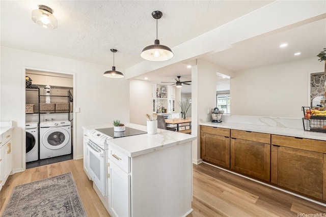 552 Kalolina St, Kailua, HI 96734 - kitchen featuring ceiling fan, pendant lighting, a center island, light wood finished floors, and washer and clothes dryer