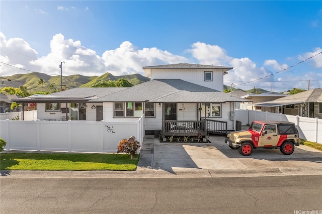 552 Kalolina St, Kailua, HI 96734 - view of front of home with fence private yard, roof with shingles, a mountain view, and covered porch