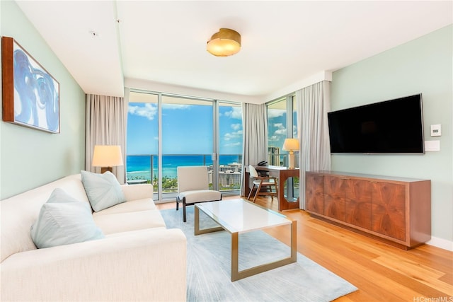 2139 Kuhio Ave Fl 34Th, Honolulu, HI 96815 - living room featuring a wall of windows, wood finished floors, and a wealth of natural light