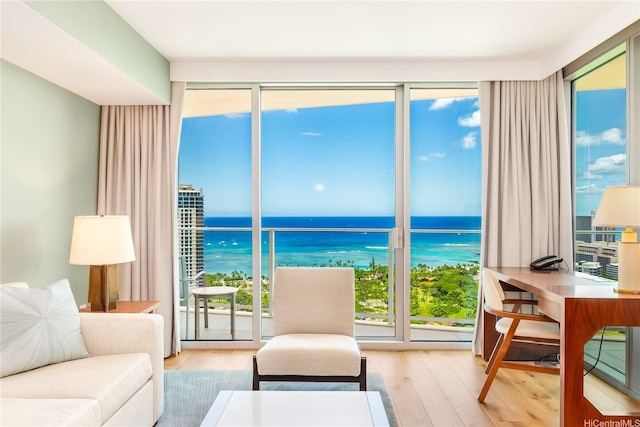 2139 Kuhio Ave Fl 34Th, Honolulu, HI 96815 - living room featuring a water view, wood finished floors, and a healthy amount of sunlight