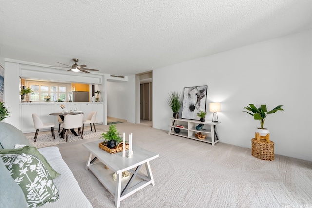 500 Lunalilo Home Rd Unit 25B, Honolulu, HI 96825 - living room with visible vents, a ceiling fan, a textured ceiling, and light colored carpet