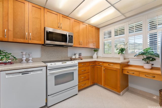 500 Lunalilo Home Rd Unit 25B, Honolulu, HI 96825 - kitchen featuring light countertops, stainless steel microwave, white range with electric stovetop, light tile patterned floors, and dishwasher