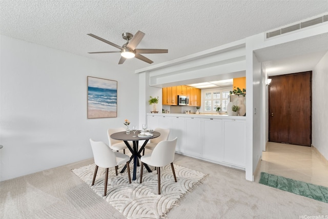 500 Lunalilo Home Rd Unit 25B, Honolulu, HI 96825 - dining room featuring a textured ceiling, ceiling fan, light colored carpet, and visible vents