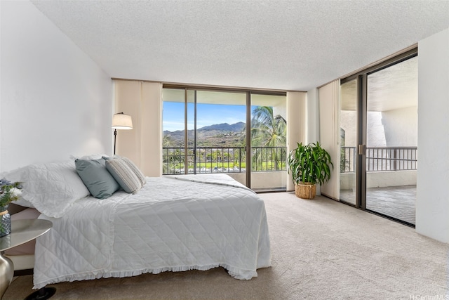 500 Lunalilo Home Rd Unit 25B, Honolulu, HI 96825 - carpeted bedroom featuring access to outside, a textured ceiling, floor to ceiling windows, and a mountain view