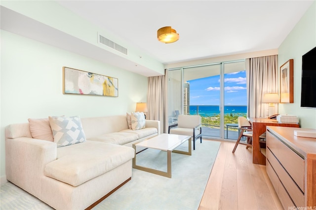 2139 Kuhio Ave Fl 27Th, Honolulu, HI 96815 - living room featuring light wood-style floors, floor to ceiling windows, and visible vents