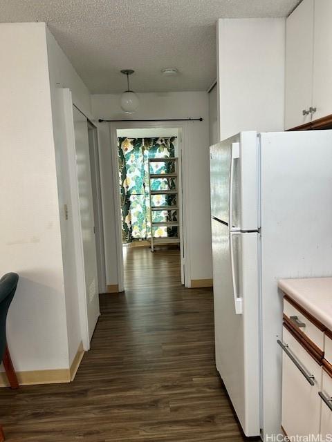 1620 Keeaumoku St Unit 404, Honolulu, HI 96822 - hall featuring baseboards, dark wood finished floors, and a textured ceiling