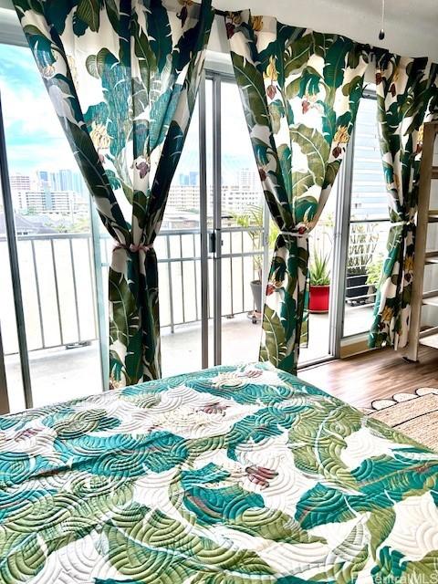 1620 Keeaumoku St Unit 404, Honolulu, HI 96822 - bedroom with a view of city, access to outside, and wood finished floors