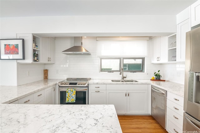 kitchen featuring a sink, open shelves, wall chimney exhaust hood, backsplash, and appliances with stainless steel finishes