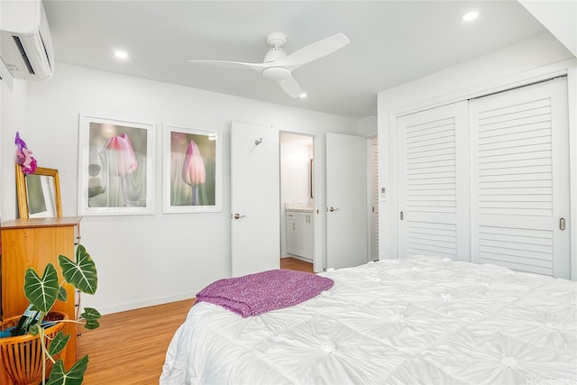 bedroom featuring recessed lighting, a closet, light wood-type flooring, and a wall mounted AC