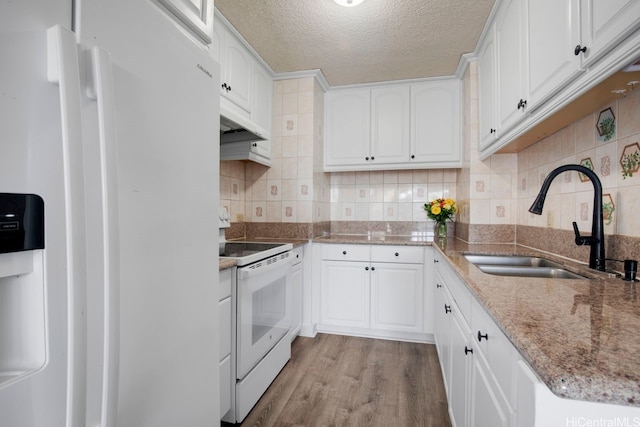 3161 Ala Ilima St Unit 811, Honolulu, HI 96818 - kitchen featuring white appliances, a sink, white cabinetry, wood finished floors, and a textured ceiling