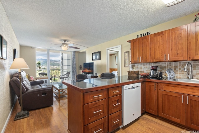2452 Tusitala St Unit 908, Honolulu, HI 96815 - kitchen with a sink, a peninsula, white dishwasher, and open floor plan