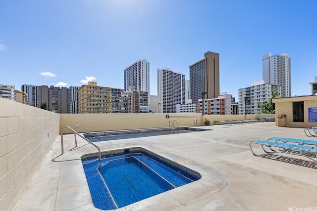 2452 Tusitala St Unit 908, Honolulu, HI 96815 - view of pool with a view of city, fence, a community hot tub, and a patio area