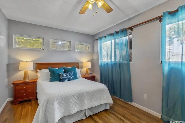 95-100 Moenamanu St Unit 458, Mililani, HI 96789 - bedroom with baseboards, wood finished floors, and a ceiling fan