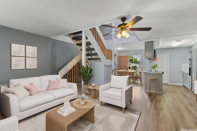 95-100 Moenamanu St Unit 458, Mililani, HI 96789 - living room featuring stairway, light wood finished floors, a ceiling fan, and baseboards
