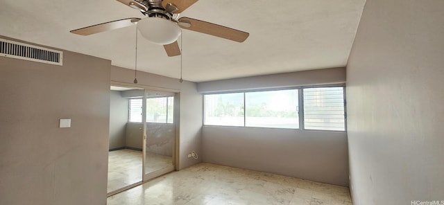 unfurnished bedroom with a closet, visible vents, ceiling fan, and tile patterned floors