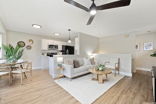91-1860 Luahoana St Unit 114, Ewa Beach, HI 96706 - living room with light wood-style flooring, baseboards, and ceiling fan