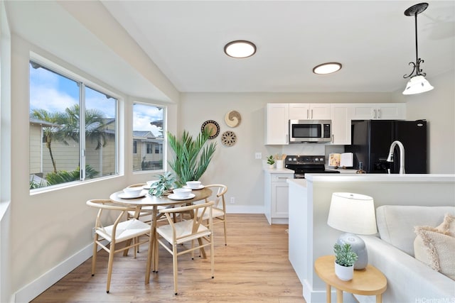 91-1860 Luahoana St Unit 114, Ewa Beach, HI 96706 - kitchen with stainless steel appliances, light wood finished floors, baseboards, and white cabinetry