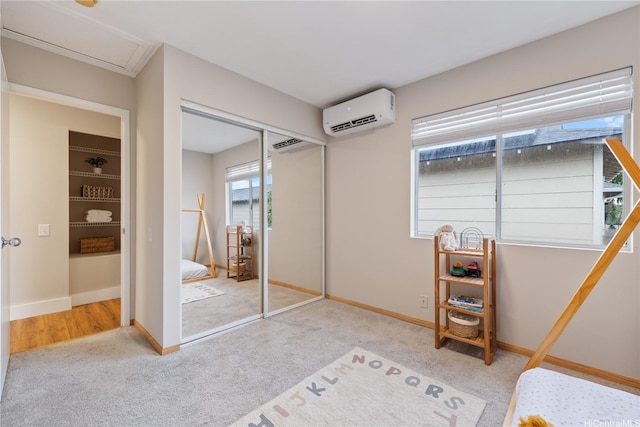 91-1860 Luahoana St Unit 114, Ewa Beach, HI 96706 - bedroom with an AC wall unit, carpet floors, a closet, and baseboards