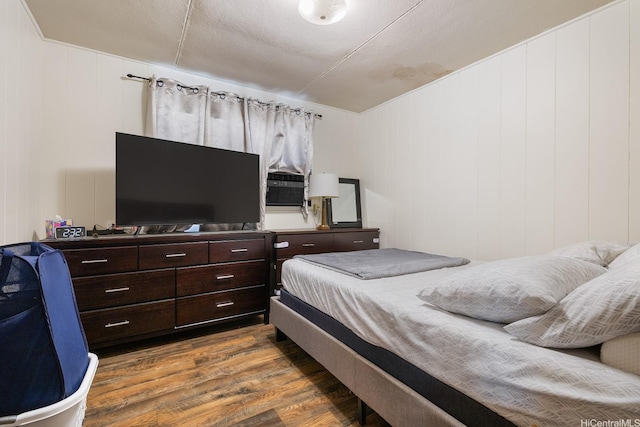 bedroom with dark wood-style flooring