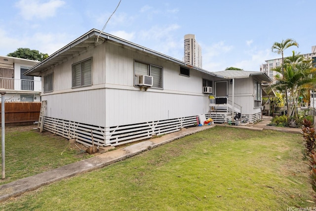 exterior space with a lawn, fence, a chimney, and cooling unit