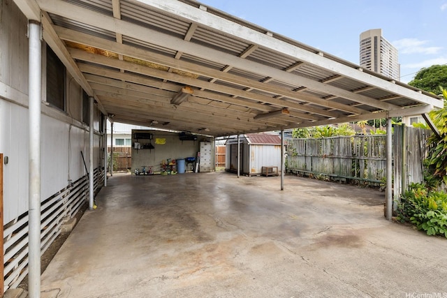 exterior space with fence, a carport, and a shed