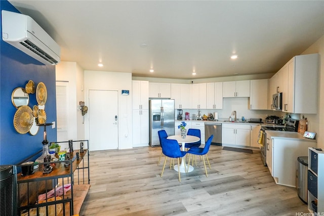 91-3633 Kauluakoko St Unit 5204, Ewa Beach, HI 96706 - kitchen featuring a wall unit AC, appliances with stainless steel finishes, a sink, light wood finished floors, and recessed lighting