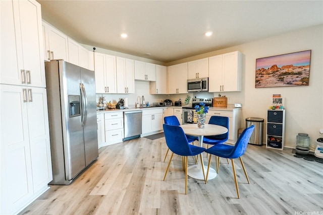 91-3633 Kauluakoko St Unit 5204, Ewa Beach, HI 96706 - kitchen featuring white cabinets, stainless steel appliances, and light wood finished floors