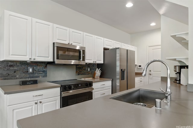 kitchen featuring recessed lighting, appliances with stainless steel finishes, a sink, and tasteful backsplash